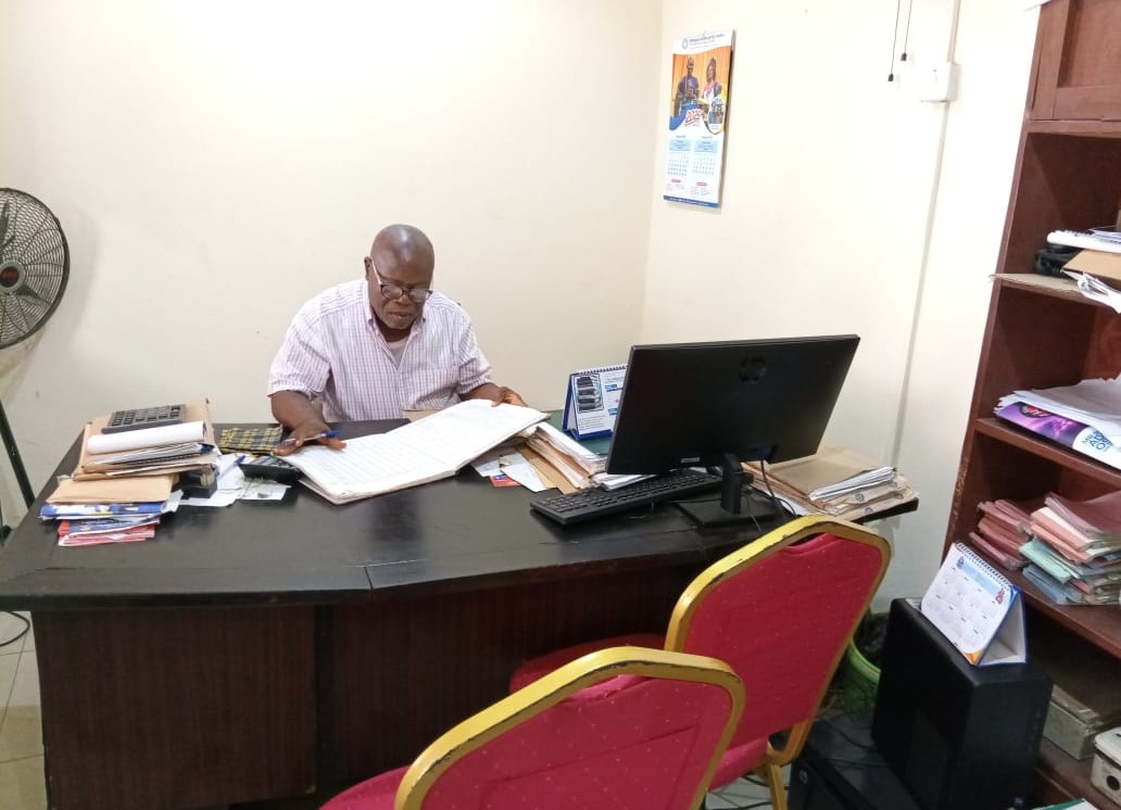 Gbagada Estate Phase II Estate Manager, Olaosebikan Ola at work at his desk in the Gbagada Estate Phase II Secretariat.